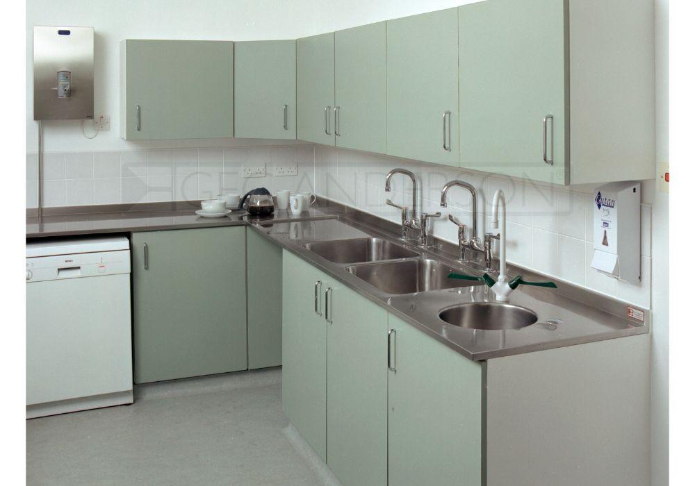 Purpose-made L-shaped stainless steel worktop with integral sink bowls and back upstands.