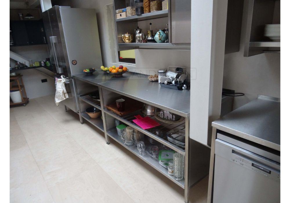 Stainless steel counters with supports and undershelves.