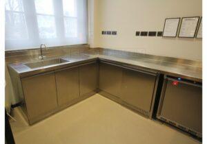 Base cabinets below stainless steel worktop.